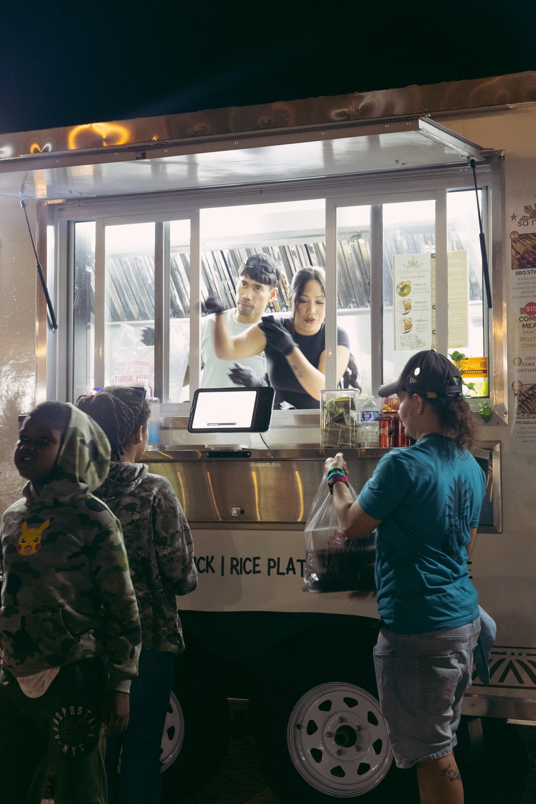 Sa Mesa food truck handing food to customers