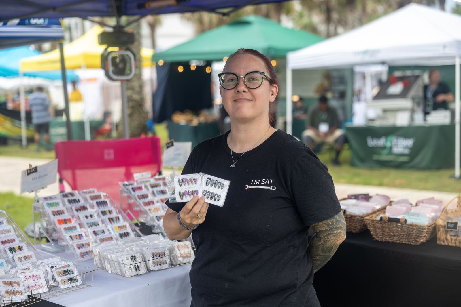 Nail art vendor showing hand-painted press-on sets