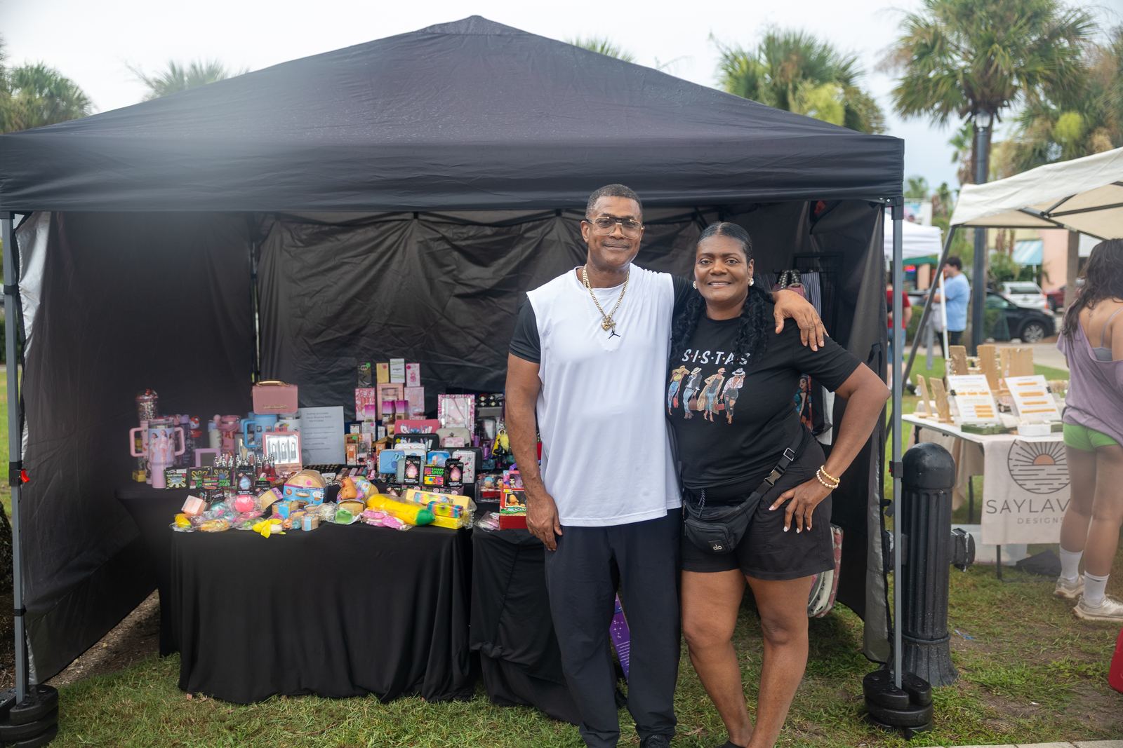 Vendor couple in front of their gift booth