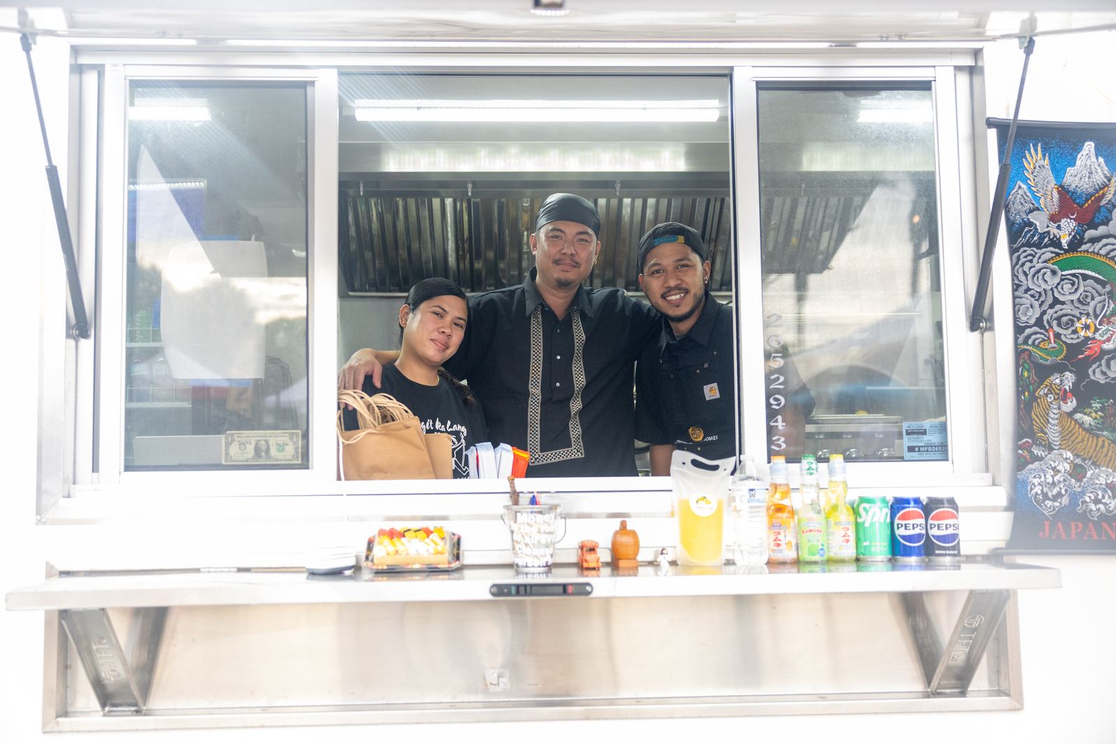 Filipino food truck crew at the service window